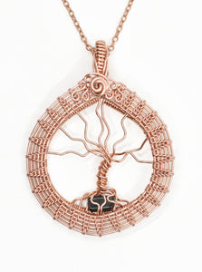 Wire wrapped copper tree of life with green tourmaline at the roots